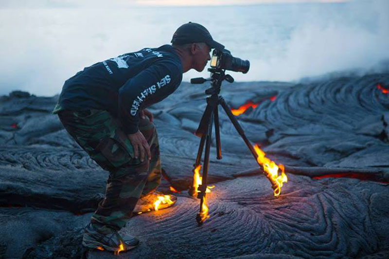 kawika-singson-standing-on-lava-shoes-tripod-on-fire