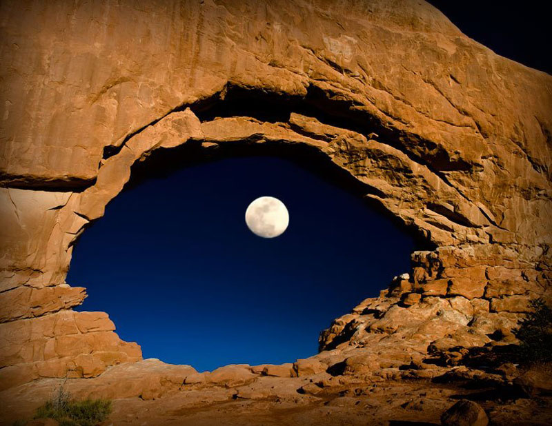 the moon through north window arches national park utah unit